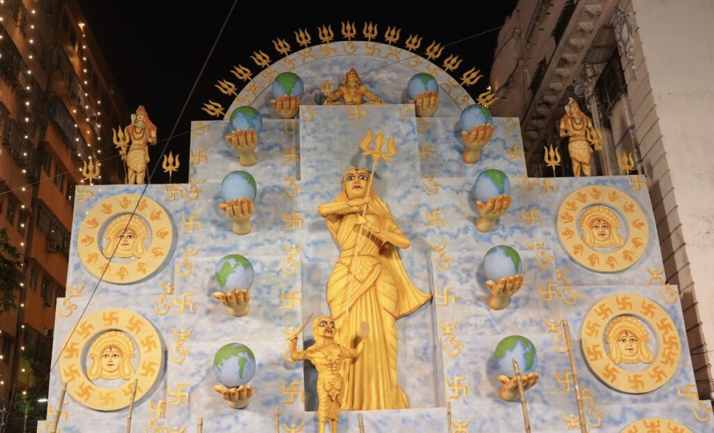 Inauguration ceremony of Young Boys Club celebrating 54th Year of Durga Puja with the theme ‘Devi Durga - The Power of Universe’ where 32 feet Durga Idol is placed outside Pandal with ten globes in her ten hands symbolizing 'Vasudhaiva Kutumbakam' - The World is one family