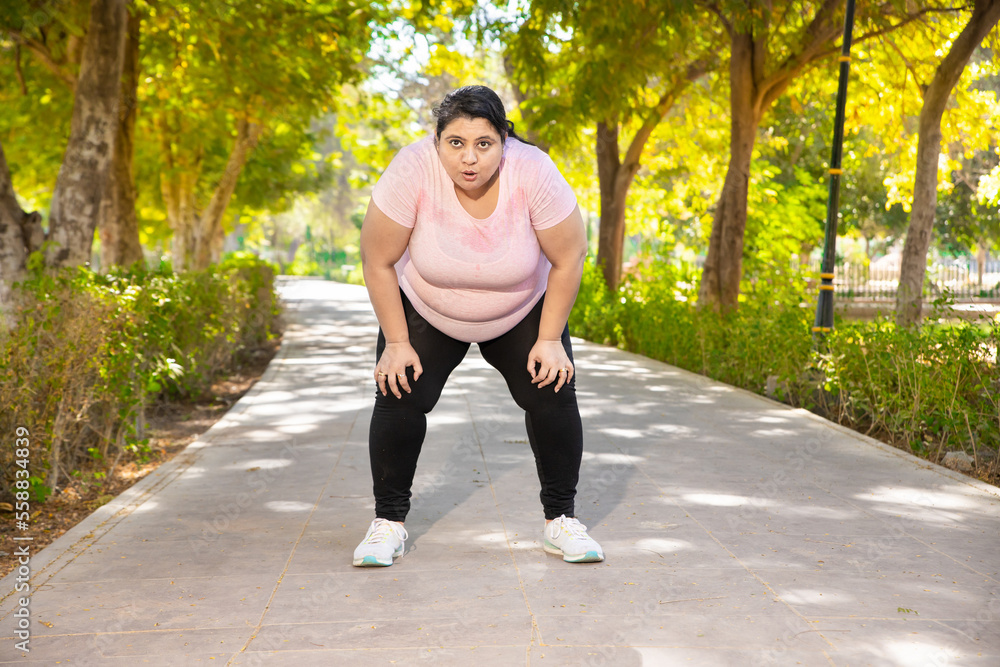 Indian woman jogging in a park as part of daily healthy habits to fight obesity