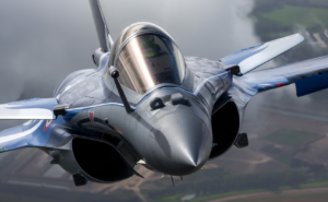 Indian Air Force Rafale fighter jet flying over mountainous terrain during combat patrol