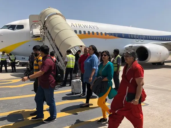 Passengers boarding a flight at an Indian airport after aviation crash news.