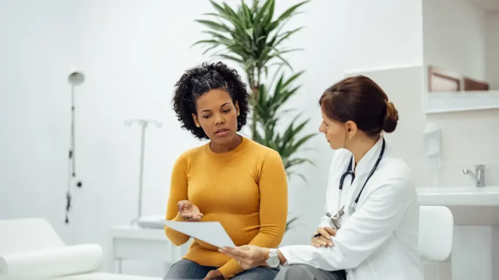 Young adult discussing appendix cancer symptoms with doctor