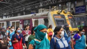 People in Kolkata wearing masks at a railway station during Covid-19 precautions in June 2025