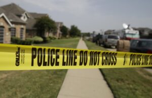 Crime scene tape outside a house where domestic violence occurred