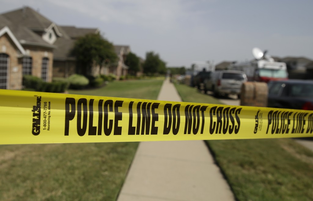 Crime scene tape outside a house where domestic violence occurred