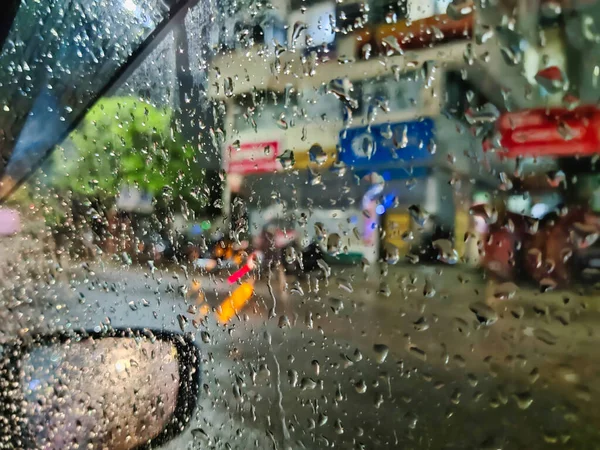 Raindrops on a window, representing recent rainfall.