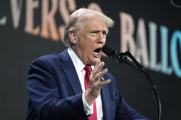 Donald Trump speaking at a conservative rally in Florida, representing right-wing opposition to progressive lawmakers.