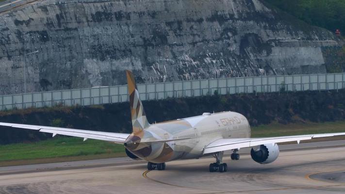 Etihad Airways Boeing 787 Dreamliner parked at an airport runwa
